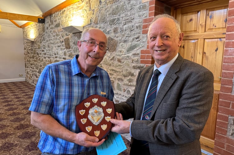Kelvin Phillips won the Devon County Ploughing AssociationVintage Hydraulic shield, presented by President Raymond Govier.  AQ 7125
