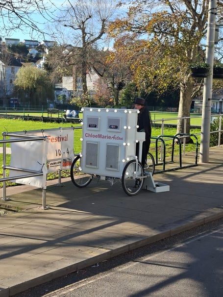 Chloe Marie Aston, the Piano Bike Girl, performing in Dawlish. Photo Ten Green Bottles. 