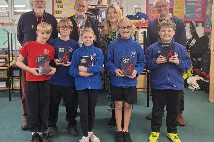 Cockwood Primary School pupils receive books from Dawlish Water Rotary club, pictured, back row left to right: Stephen Allen, Ed McLaughlin, head Alison Roper, and David Lupton