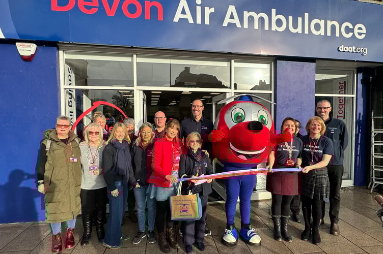 Devon Air Ambulance Founder and Life President Ann Ralli, centre, cut a ribbon to officially open its newest charity shop.  AQ 0035
