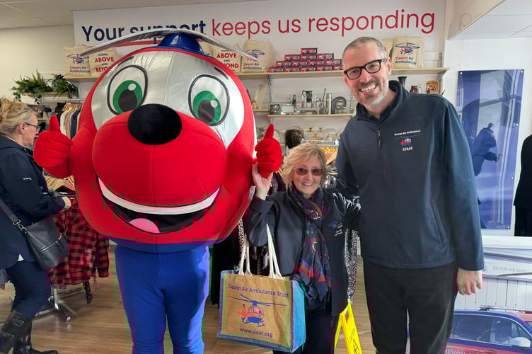 Ann Ralli, centre, with the Devon Air Ambulance mascot Jennie and Matthew Bell, the charity’s director of public engagement. AQ 0061