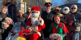 Santa delivers gifts by scooter to Salvation Army
