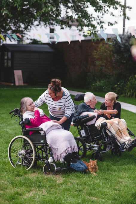 Julie Yates and Lisa Burge from the Sefton Hall care team spend time with two residents in the garden. Photo contributed