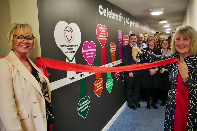 The commemorative timeline at Westbank unveiled by CEO Sarah Hicks, left, the founder Mary Nesbitt, right. Photo Sharon Goble 