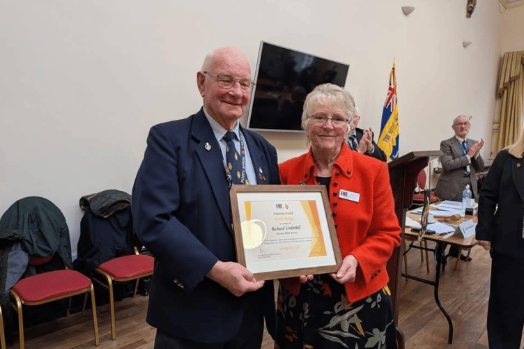 Richard receiving his award from Jan Buxton on behalf of the National Chairman.