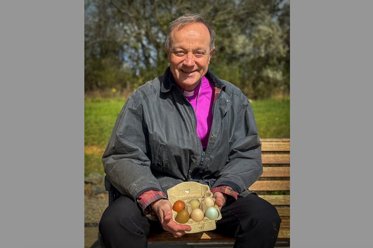Bishop Mike with eggs during his recent farm visit at North Tawton.