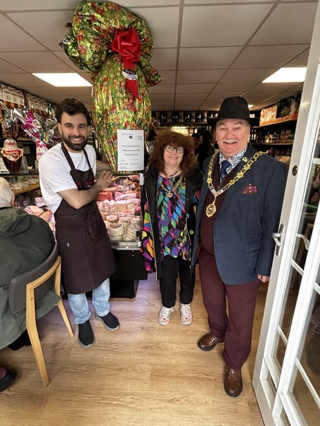 Mayor of Newton Abbot Cllr Colin Parker and wife Jean with Manager Deler Hussaini at new The Italian Store. The business organised an Easter raffle, the proceeds of which go to the Mayor’s charities. Photo contributed 
