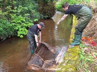 Volunteers remove mattress dumped in waterway