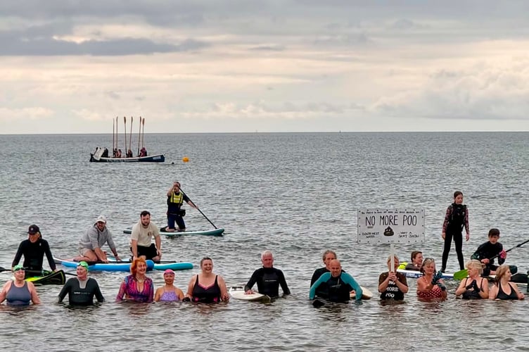 Protesters in the water at Teignmouth's Paddle Out event. Photo Stuart Reynolds