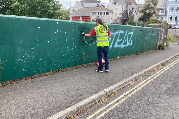 Guerrilla Gardeners remove graffiti in Teignmouth. Photo Iain Franklin 