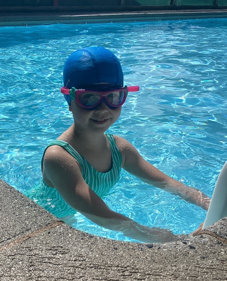 A pupil in the pool at Dunsford Community Academy during a summer swimming lesson