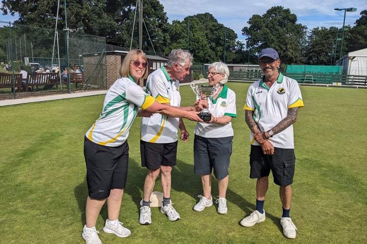 Organiser Heidi Call presents the winners' trophy to Steve Callard, Christina Towle and Ken Isaaks