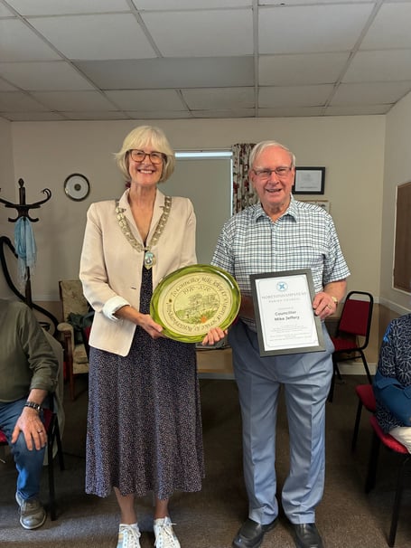 Mike Jeffery being presented with a commemorative plate by parish council chair Catherine Fileman-Wright