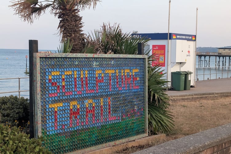 The TRAIL sculpture display sign on Teignmouth seafront
