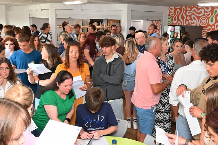 GCSE results day at Newton Abbot's Coombeshead Academy. Students, parents and teaching staff crowd the dining hall for the results