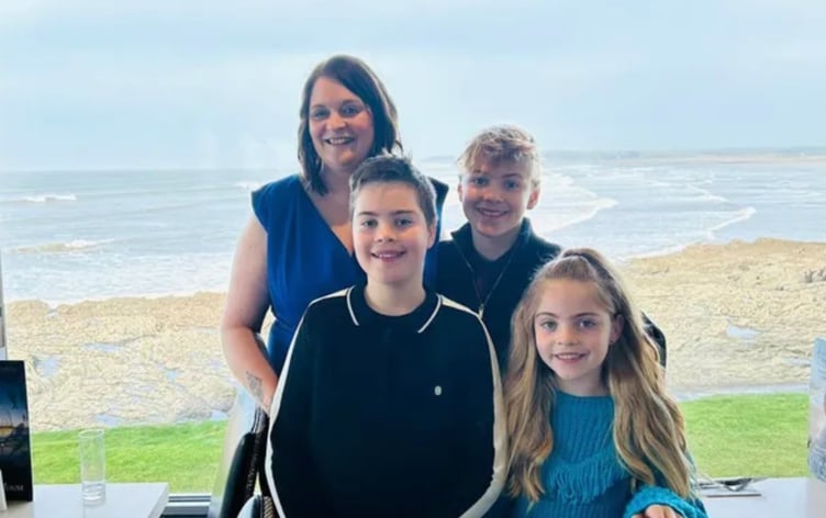 Erin Hooper, from Teignmouth, who died suddenly, with her three children. Photo Go Fund Me
