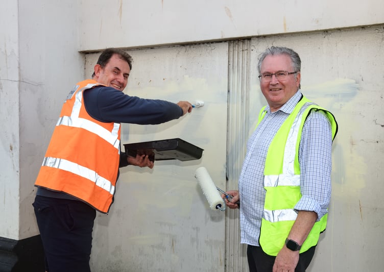 Cllrs Mike Jackman and David Cox painting over graffiti tags on Teignmouth Post Office